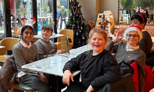 Earth class sitting down for their meal at Pizza Express